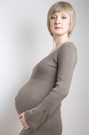 simsearch:400-04396054,k - full-body portrait of a pregnant woman in a dark beige dress Stock Photo - Budget Royalty-Free & Subscription, Code: 400-04098082