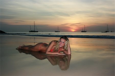 simsearch:400-07748817,k - Woman lying on the sand beach at sunset Stock Photo - Budget Royalty-Free & Subscription, Code: 400-04098156