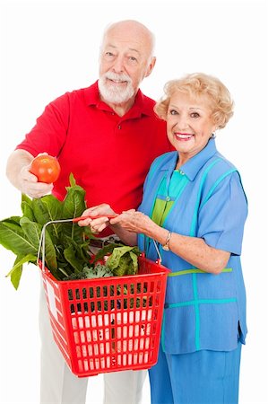 Healthy senior couple shopping for organic produce.  Isolated on white. Stock Photo - Budget Royalty-Free & Subscription, Code: 400-04092042