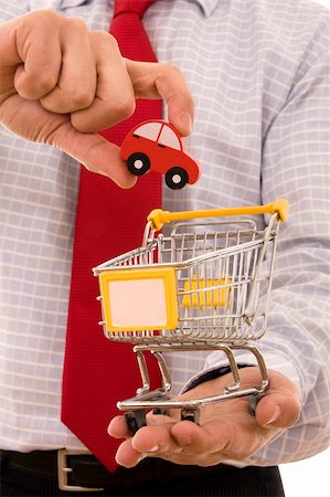 simsearch:400-04321973,k - Shopping concept - Hand putting a car on a trolley shop Stock Photo - Budget Royalty-Free & Subscription, Code: 400-04104173