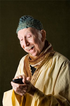 simsearch:400-05372618,k - Wise Man with Knit Cap Using Cell Phone Stock Photo - Budget Royalty-Free & Subscription, Code: 400-04106900