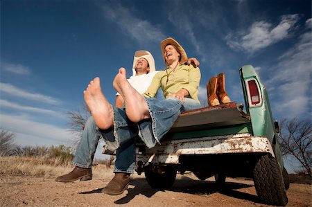 Portrait of Cowboy and woman on pickup truck bed Stock Photo - Budget Royalty-Free & Subscription, Code: 400-04107126