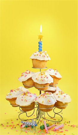 simsearch:400-04764403,k - Cupcakes on multi-tiered stand with candle on yellow background Stock Photo - Budget Royalty-Free & Subscription, Code: 400-04107368