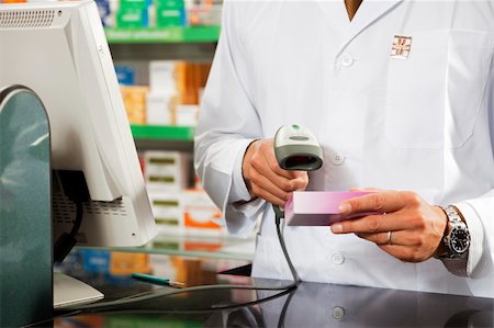 simsearch:400-04106195,k - cropped view of pharmacist scanning medicine with barcode reader Stock Photo - Budget Royalty-Free & Subscription, Code: 400-04107632