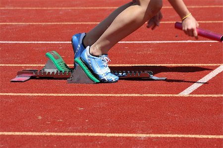 Runner leaving starting blocks with baton Stock Photo - Budget Royalty-Free & Subscription, Code: 400-04108540