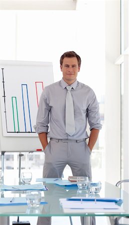 simsearch:400-05710386,k - Man standing before his team at a presentation Stock Photo - Budget Royalty-Free & Subscription, Code: 400-04109280