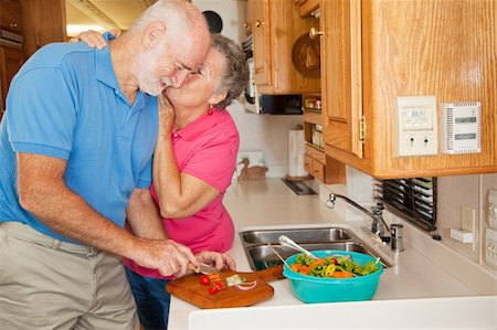 Senior man helping his wife in the kitchen of their RV gets rewarded with a kiss. Stock Photo - Budget Royalty-Free & Subscription, Code: 400-04109834