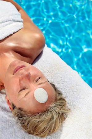 simsearch:400-05318677,k - Woman at a spa with white stone on her forehead Stock Photo - Budget Royalty-Free & Subscription, Code: 400-04117975
