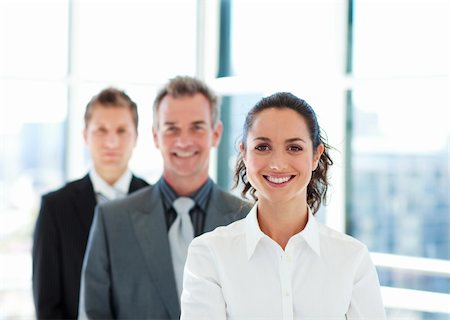 Smiling young businesswoman in front of her team Stock Photo - Budget Royalty-Free & Subscription, Code: 400-04118170