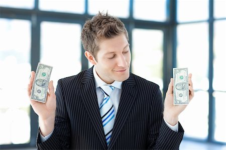 simsearch:400-05718324,k - Smiling businessman holding money in office Stock Photo - Budget Royalty-Free & Subscription, Code: 400-04118211