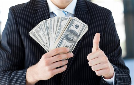 simsearch:400-05718324,k - Attractive businessman showing dollars with thumbs up Stock Photo - Budget Royalty-Free & Subscription, Code: 400-04118212