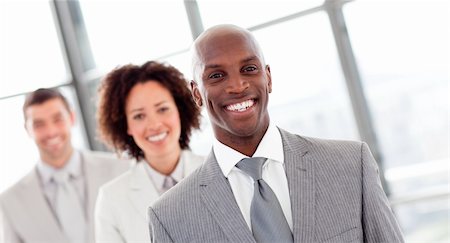 Smiling African businessman in a row Stock Photo - Budget Royalty-Free & Subscription, Code: 400-04118243