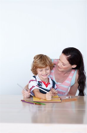 simsearch:400-05749563,k - Mother and son writing together at home with copy-space Stock Photo - Budget Royalty-Free & Subscription, Code: 400-04118431