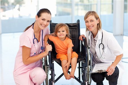 Baby in a wheelchair with attractive nurse and doctor Stock Photo - Budget Royalty-Free & Subscription, Code: 400-04118494