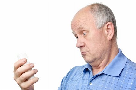 funny old people faces - senior bald man is examining something in his hand Stock Photo - Budget Royalty-Free & Subscription, Code: 400-04118827