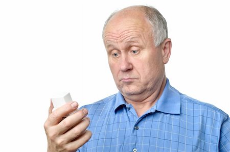 funny old people faces - senior bald man is examining something in his hand Stock Photo - Budget Royalty-Free & Subscription, Code: 400-04118828