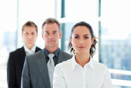 Serious young businesswoman in front of her team Stock Photo - Budget Royalty-Free & Subscription, Code: 400-04119261