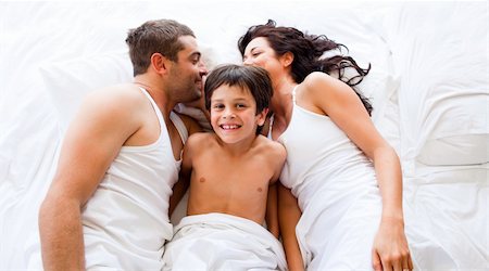 Happy couple and son lying in bed Stock Photo - Budget Royalty-Free & Subscription, Code: 400-04119382