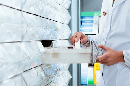 simsearch:400-04106195,k - cropped view of pharmacist taking medicine from drawer. Copy space Stock Photo - Budget Royalty-Free & Subscription, Code: 400-04110176