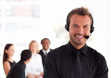 simsearch:400-03933798,k - Young Businessman with headset on in office environment Stock Photo - Budget Royalty-Free & Subscription, Code: 400-04111008