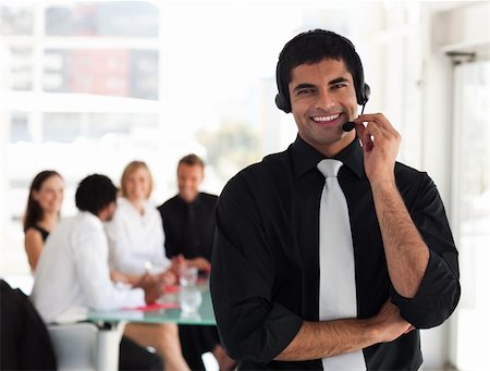 simsearch:400-03933798,k - Young Businessman talking on a headset Stock Photo - Budget Royalty-Free & Subscription, Code: 400-04111030