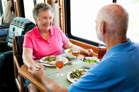 simsearch:400-04208630,k - Senior couple holding hands about to eat a healthy meal in their motor home. Stock Photo - Budget Royalty-Free & Subscription, Code: 400-04124572