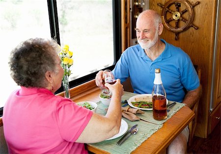 simsearch:400-04208630,k - Senior couple enjoys a romantic meal in the kitchen of their motor home. Stock Photo - Budget Royalty-Free & Subscription, Code: 400-04124573