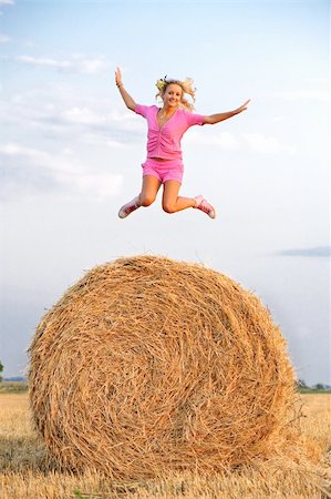 blond girl jumping high at the field Stock Photo - Budget Royalty-Free & Subscription, Code: 400-04124785