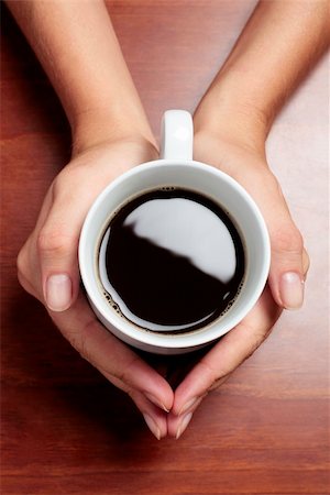 spanishalex (artist) - Womans hands holding a cup of coffee on a dark table Stock Photo - Budget Royalty-Free & Subscription, Code: 400-04126166