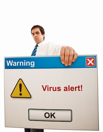 simsearch:400-03933798,k - Serious businessman holding computer message with virus alert - isolated, wide-angle, focus on panel Stock Photo - Budget Royalty-Free & Subscription, Code: 400-04129519