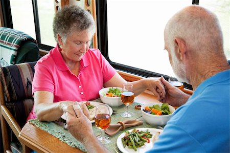 Senior couple says a prayer over a healthy turkey dinner served in the kitchen of their mobile home. Stock Photo - Budget Royalty-Free & Subscription, Code: 400-04121873