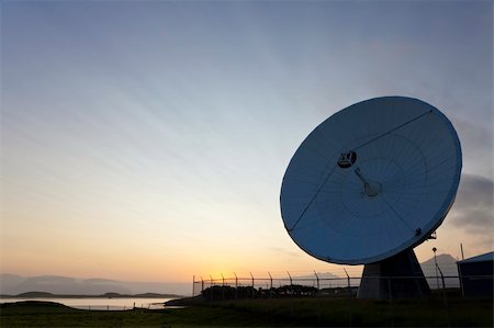 radio telescope - A radio telescope at sunset with the sun going down behind it producing amazing cloud strata pattern. Stock Photo - Budget Royalty-Free & Subscription, Code: 400-04137810