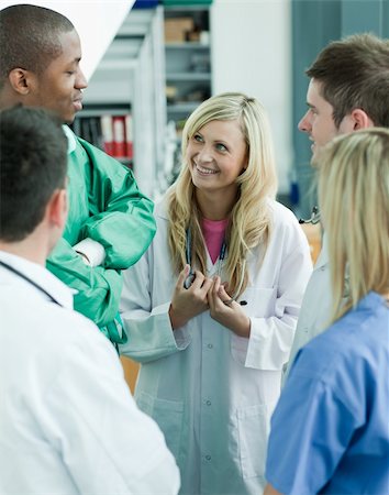 patient nurse talking office - Group of doctors speaking in a hospital office and smiling Stock Photo - Budget Royalty-Free & Subscription, Code: 400-04138347