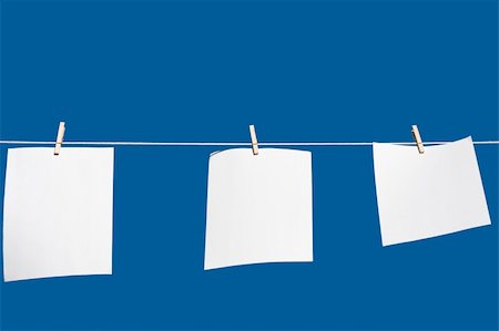 peg - paper hanging from a clothes line with a blue background Stock Photo - Budget Royalty-Free & Subscription, Code: 400-04138650