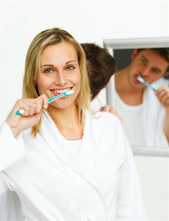 simsearch:400-04151135,k - Smiling woman cleaning her teeth with her boyfriend in bathroom Stock Photo - Budget Royalty-Free & Subscription, Code: 400-04139530