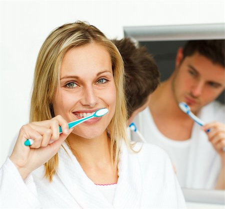 simsearch:400-04151135,k - Portrait of an attractive woman cleaning her teeth with her boyfriend in bathroom Stock Photo - Budget Royalty-Free & Subscription, Code: 400-04139531