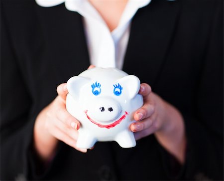 simsearch:400-05715208,k - Young businesswoman holding a funky piggy bank Stock Photo - Budget Royalty-Free & Subscription, Code: 400-04130627