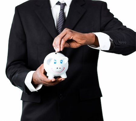 simsearch:400-05718324,k - Close-up of an Afro-American businessman putting money in his piggybank Stock Photo - Budget Royalty-Free & Subscription, Code: 400-04130699