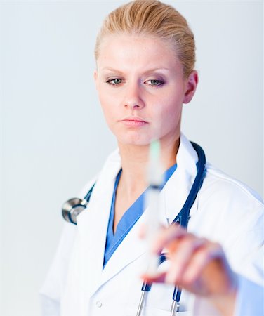 Serious Doctor holding a needle with camera focus on the doctor Stock Photo - Budget Royalty-Free & Subscription, Code: 400-04130786
