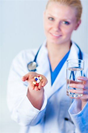 simsearch:400-05748252,k - Young female Doctor holding pills out Stock Photo - Budget Royalty-Free & Subscription, Code: 400-04130794