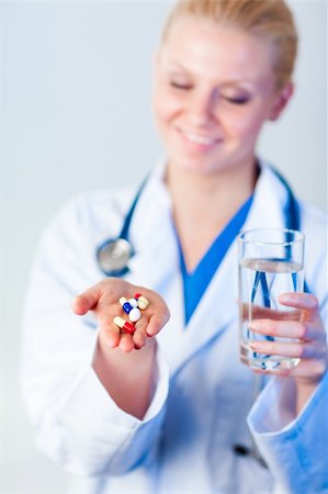 simsearch:400-05748252,k - Young female Doctor holding pills out Stock Photo - Budget Royalty-Free & Subscription, Code: 400-04130793