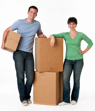 A couple is standing next to moving boxes and they are smiling at the camera.  Vertically framed shot. Stock Photo - Budget Royalty-Free & Subscription, Code: 400-04130877