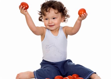 Child with tomato, isolated on a white background. Stock Photo - Budget Royalty-Free & Subscription, Code: 400-04133932