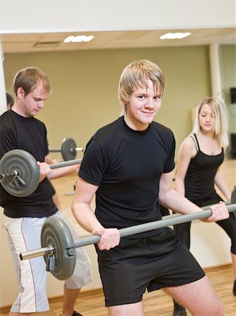 simsearch:400-04148009,k - Group of people lifting weights with a young man in focus Photographie de stock - Aubaine LD & Abonnement, Code: 400-04149243