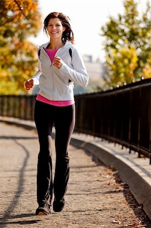 A young woman jogging on a path in a park Stock Photo - Budget Royalty-Free & Subscription, Code: 400-04149630