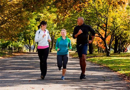 Three young adults jogging in the park Stock Photo - Budget Royalty-Free & Subscription, Code: 400-04149631