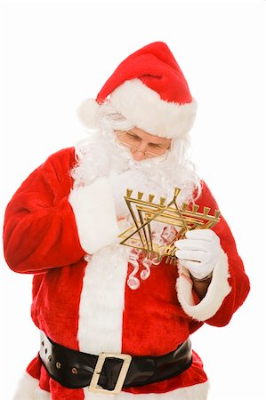 simsearch:400-06462885,k - Confused Santa Claus looking at a Chanukah menorah.  Isolated on white. Stock Photo - Budget Royalty-Free & Subscription, Code: 400-04149780