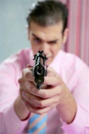 simsearch:400-04131198,k - Businessman point his handgun to camera, wallpaper background Stock Photo - Budget Royalty-Free & Subscription, Code: 400-04140621