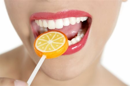 simsearch:400-04932642,k - Lollypop coloré à dents femme parfaite et de la bouche des lèvres rouges Photographie de stock - Aubaine LD & Abonnement, Code: 400-04140678
