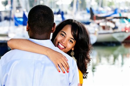 Beautiful young woman hugging boyfriend standing at harbor Stock Photo - Budget Royalty-Free & Subscription, Code: 400-04155050